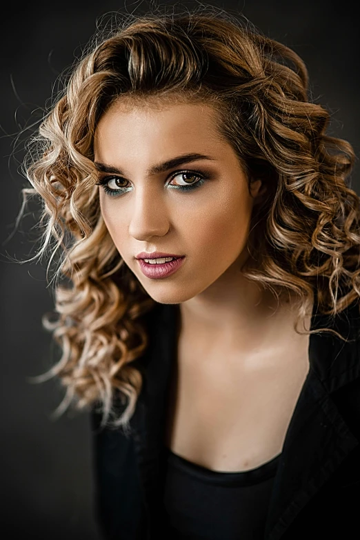 a woman with curly hair posing for a picture, black backdrop!, portrait sophie mudd, professional studio lightening, closeup!!!!!!