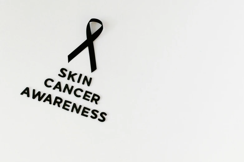 a black ribbon with the words skin cancer awareness on it, trending on pexels, photoshoot for skincare brand, profile picture 1024px, slim, various posed