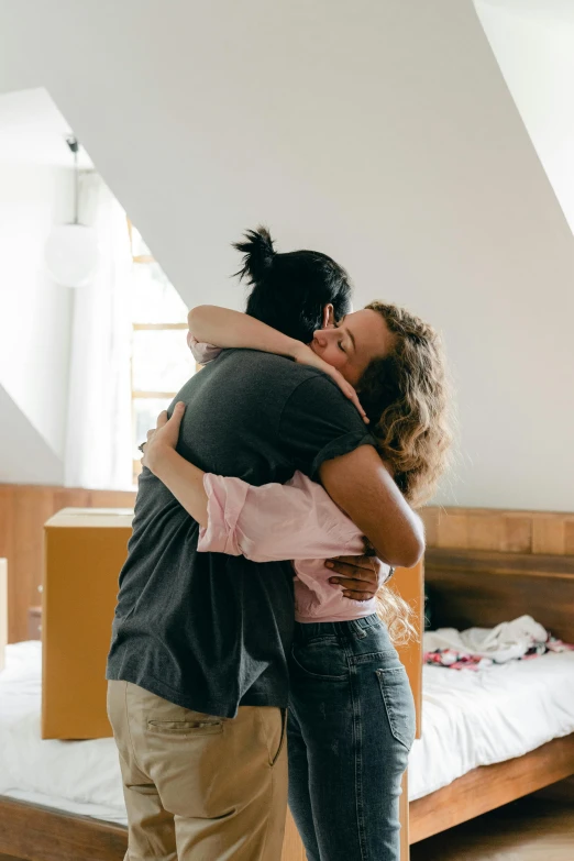 a man and woman hugging each other in a bedroom, pexels contest winner, leaving a room, celebrating, placed in a living room, promo image