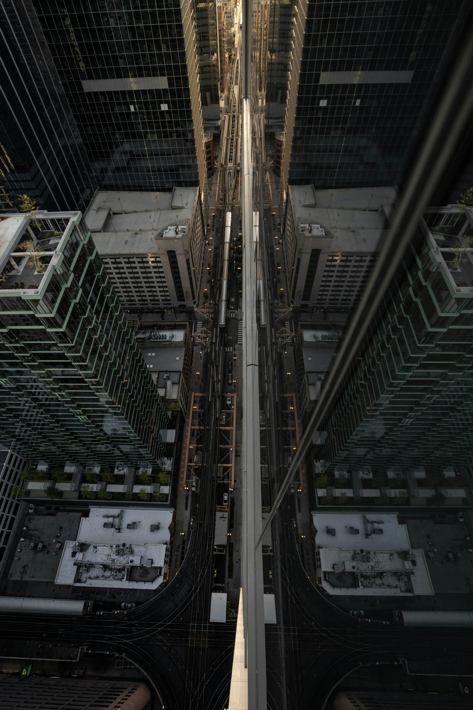 a view of a city from the top of a building, inspired by Thomas Struth, head straight down, mechanical superstructure, infinite hallway, taken in 2022