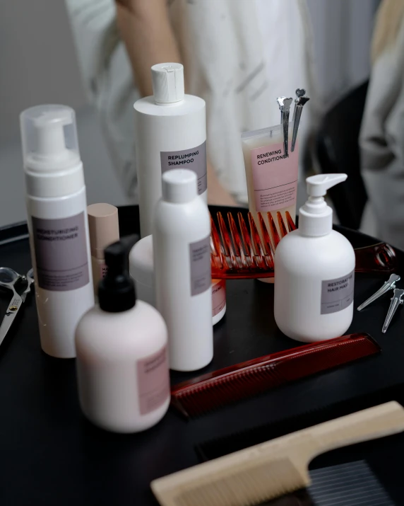 a table topped with lots of different types of hair products, trending on unsplash, jakarta, low quality photo, thumbnail, college