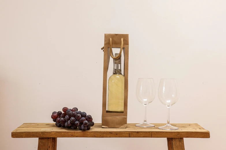 a bottle of wine sitting on top of a wooden table, inspired by William Nicholson, renaissance, white, 4l, upcycled, wooden casing