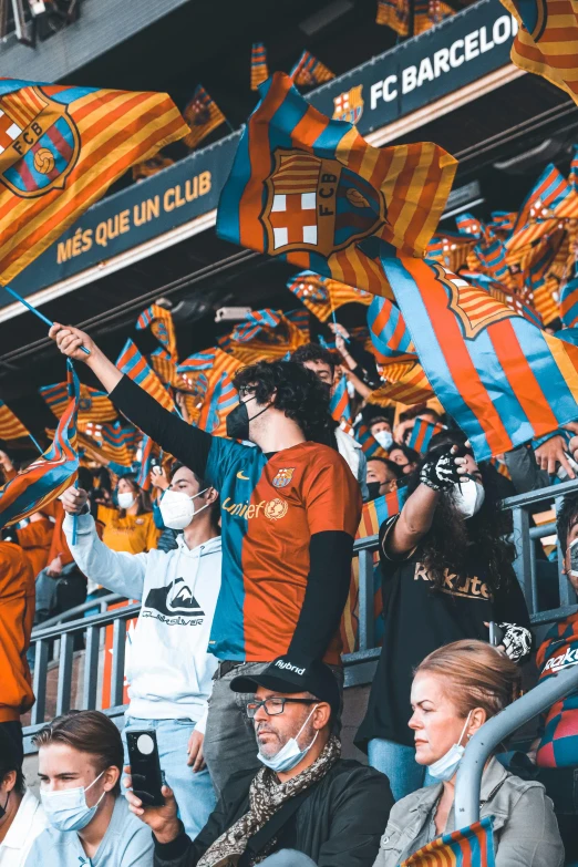 a group of people sitting next to each other at a soccer game, inspired by Francisco de Holanda, pexels contest winner, teal and orange, taken on iphone 14 pro, 2 5 6 x 2 5 6, wearing a barca cape