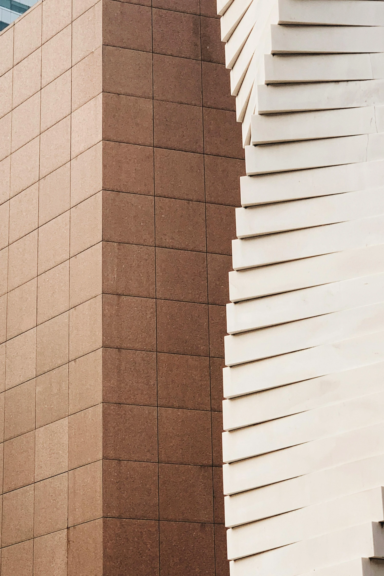 a tall building with a clock on top of it, an abstract sculpture, inspired by Kay Sage, unsplash, detail texture, light - brown wall, tiles, folded