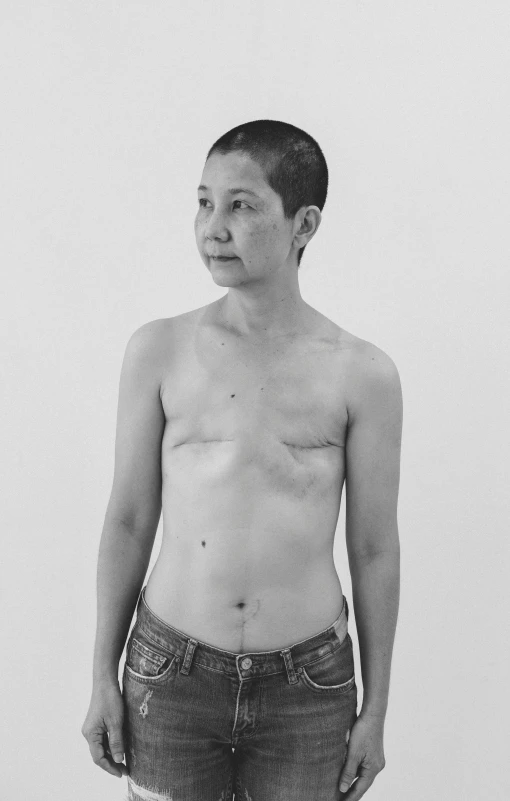 a black and white photo of a man with no shirt, inspired by Zhang Kechun, an asian woman, battle scars across body, with short hair, catalogue photo