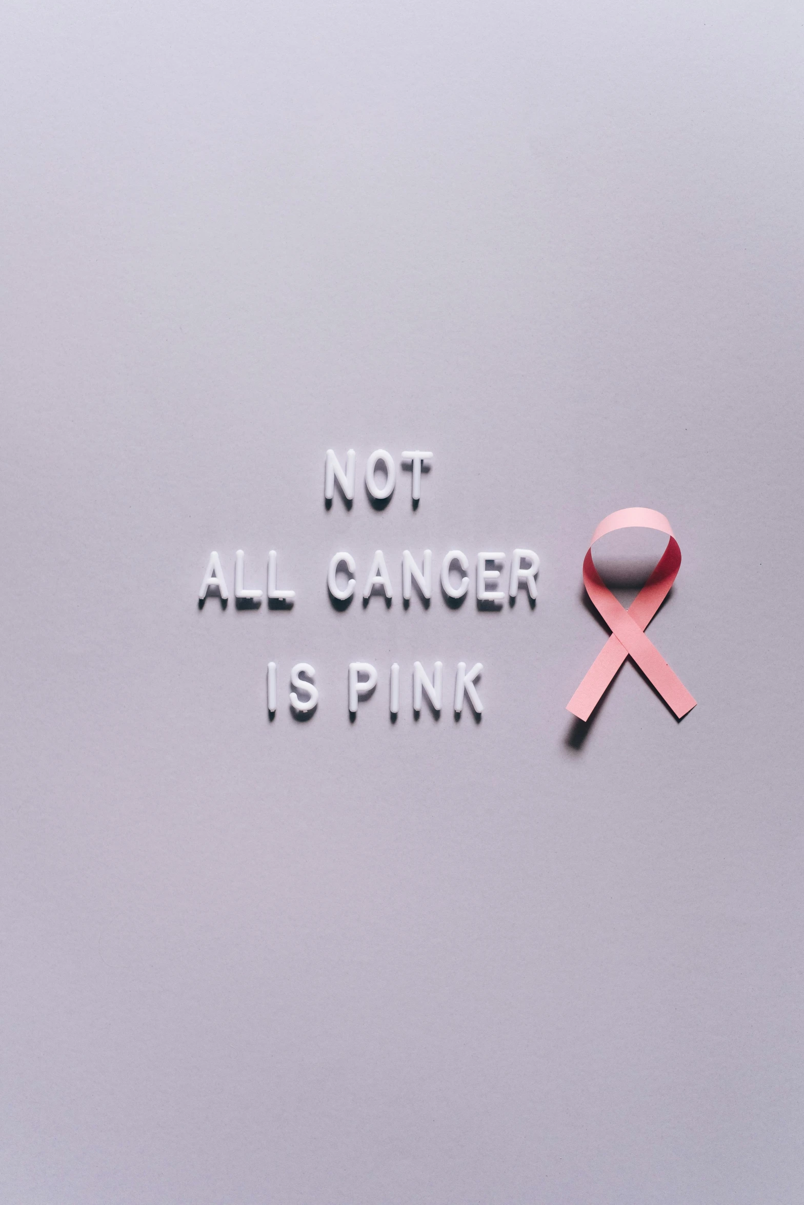 a pink ribbon with the words not all cancer is pink, by Alison Geissler, pexels contest winner, renaissance, single color, instagram picture, panel, 2070