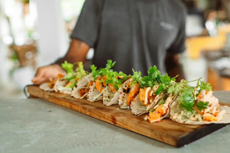 a close up of a plate of food on a table, on a wooden tray, tacos, profile image, group photo