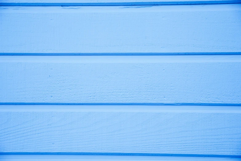 a close up of a blue wooden wall