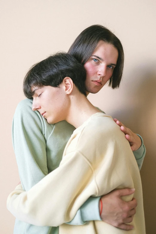 a couple of women standing next to each other, by Nina Hamnett, two men hugging, timid and vulnerable expression, non-binary, teenage boy