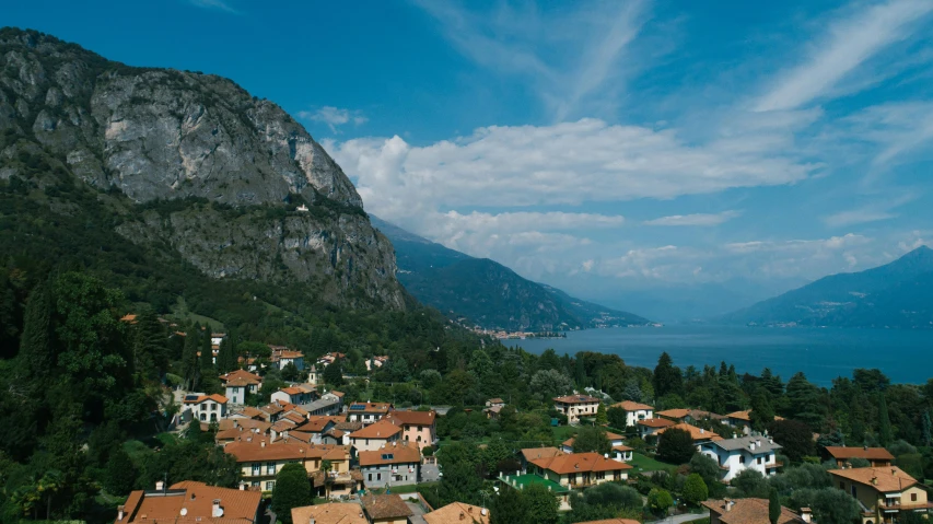 a group of houses sitting on top of a lush green hillside, pexels contest winner, renaissance, mountains and lakes, vouge italy, flat lay, sunny day time