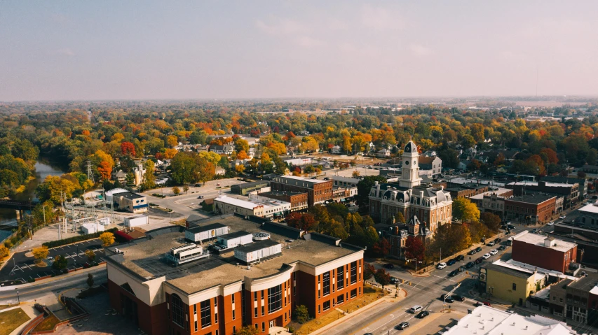 an aerial view of a city with a clock tower, by Carey Morris, unsplash contest winner, bentonville arkansas, chesterfield, brown, afternoon