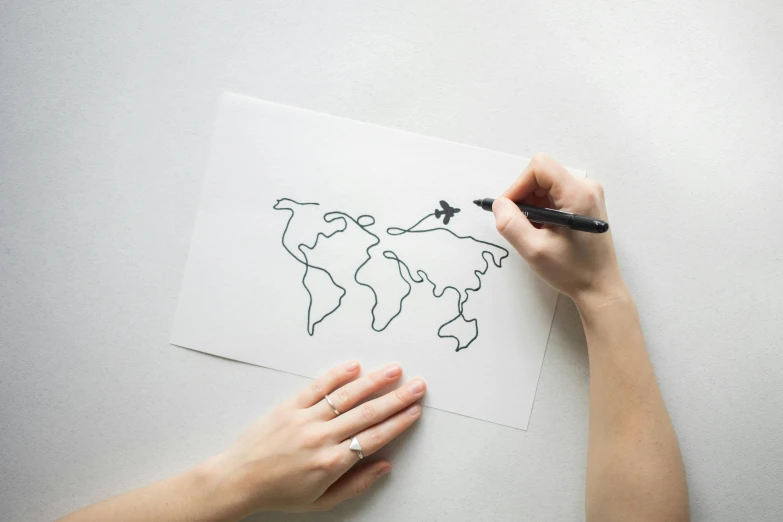 a person drawing a world map on a piece of paper, a drawing, by Will Ellis, modern european ink painting, paper airplane, glowforge template, childrens drawing, realistic line drawing