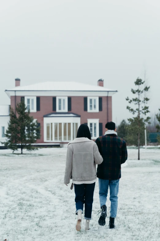 a couple of people that are walking in the snow, inspired by Gregory Crewdson, unsplash, mansion, [ cinematic, scenic full shot, scene from live action movie