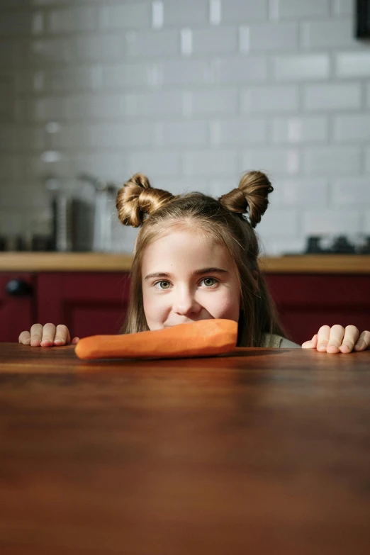 a little girl sitting at a table with a carrot in her mouth, pexels contest winner, square nose, cooking show, girl with warship parts, perfect shape