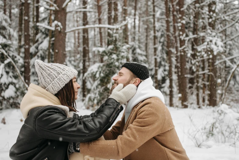 a man and woman standing next to each other in the snow, pexels contest winner, beanie, avatar image, man grabbing a womans waist, outdoor photo