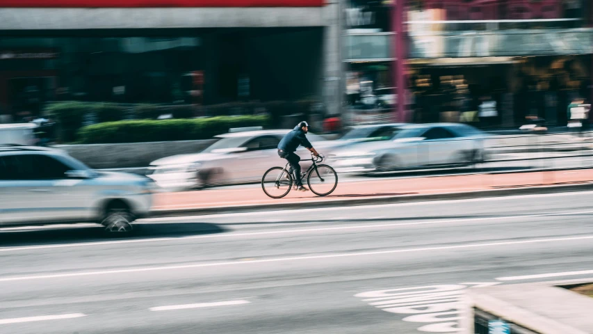 a man riding a bike down a city street, pexels contest winner, bay area, worksafe. instagram photo, no watermarks, 🚿🗝📝