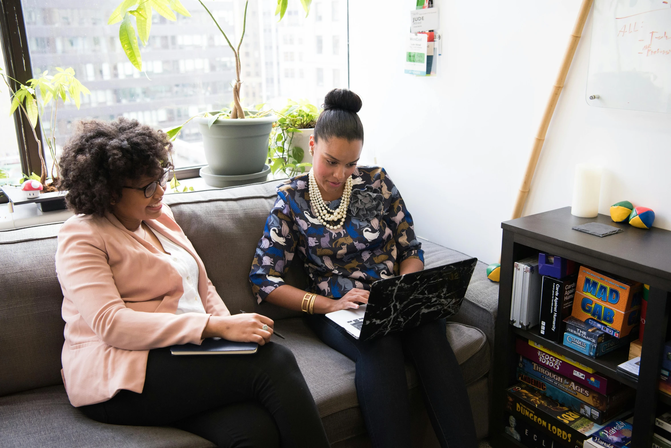 two women sitting on a couch using laptops, by Arabella Rankin, pexels contest winner, sitting in dean's office, imane anys, overlooking, teaching