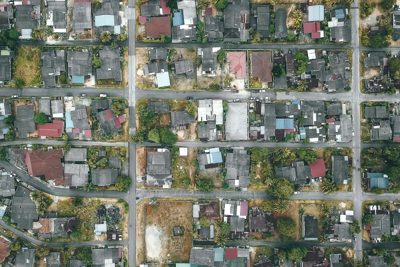 an aerial view of a city with lots of houses, a colorized photo, by Carey Morris, conceptual art, empty streetscapes, hi-res, panel, drone photo