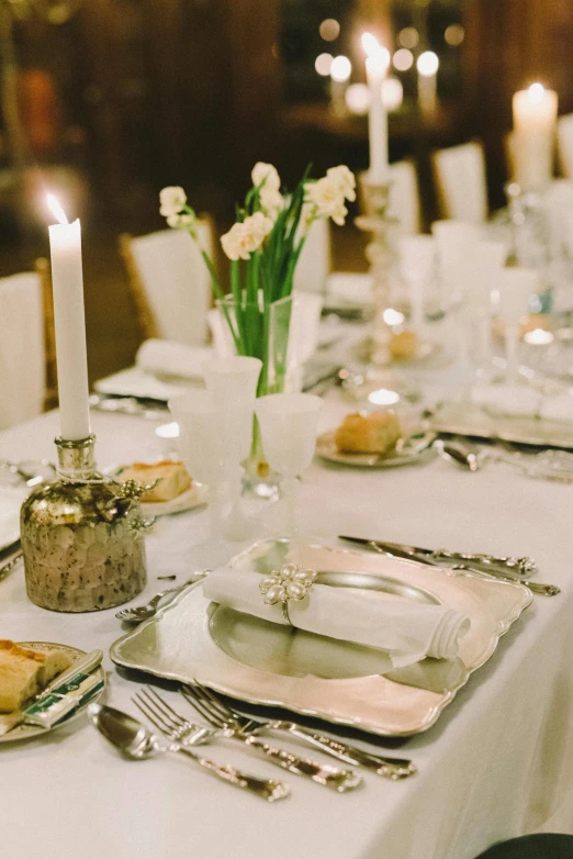 a table that has a bunch of place settings on it, inspired by Ramon Pichot, unsplash, renaissance, silver，ivory, evening lighting, holy ceremony, square