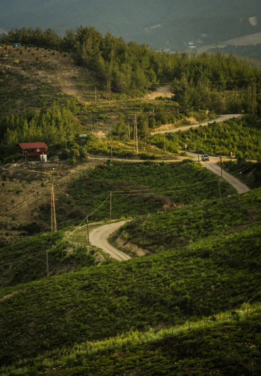 a dirt road winding through a lush green hillside, an album cover, by Tobias Stimmer, sumatraism, portugal, early evening, square, overview