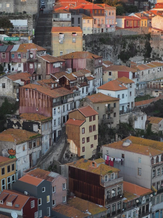 a view of a city from the top of a hill, inspired by Almada Negreiros, pexels contest winner, renaissance, shanty townships, slide show, red building, in muted colors