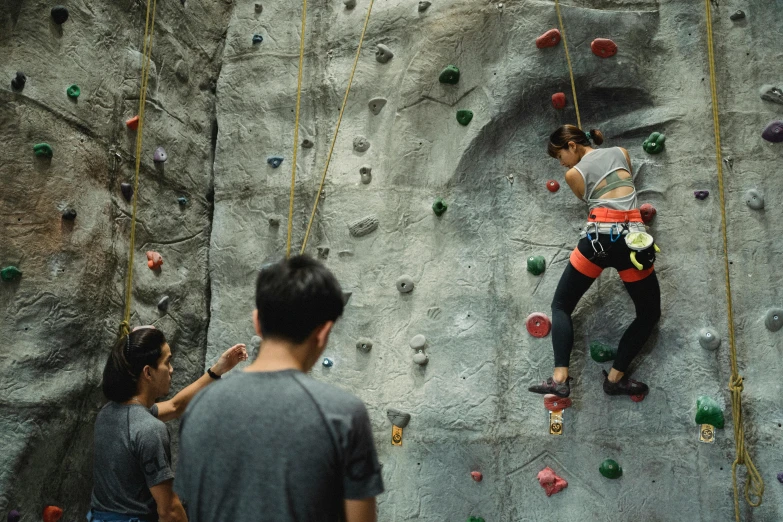 a group of people climbing on a rock wall, singapore, fan favorite, vsx, mid 2 0's female