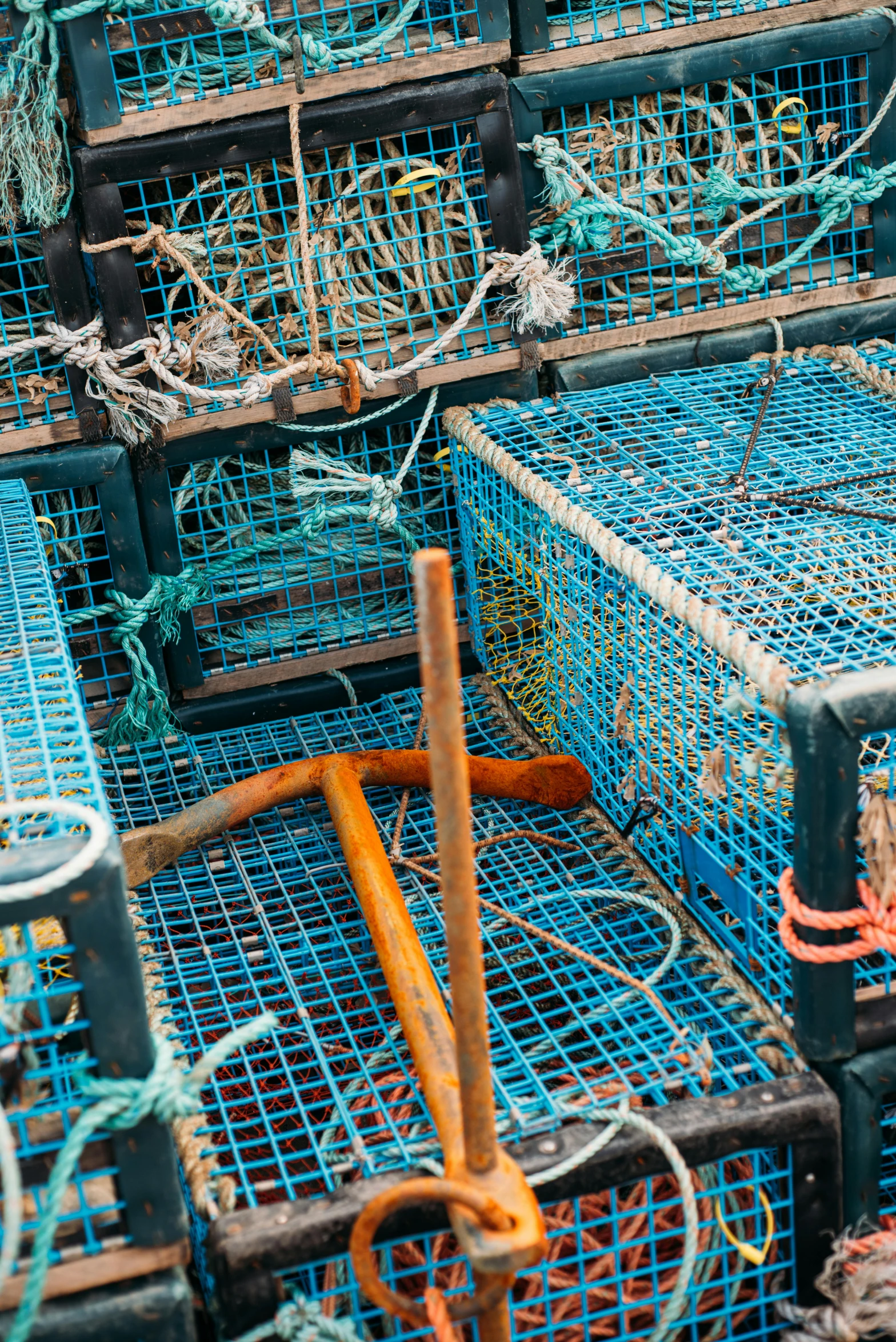 a pile of lobster traps stacked on top of each other, an album cover, by Matt Cavotta, pexels, square, blue, harnesses, four legged