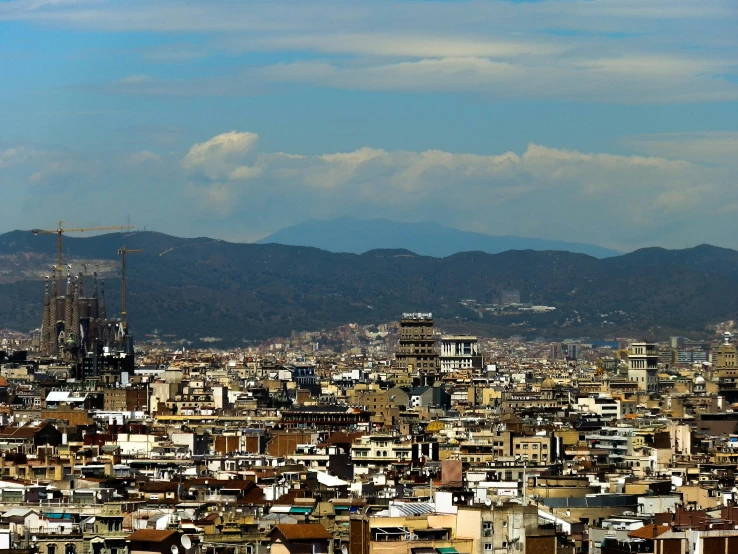 a view of a city with mountains in the background, by Tomàs Barceló, pexels contest winner, baroque, naoya tanaka, view from side, slide show, wide high angle view