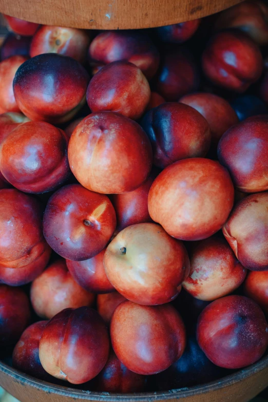 a bucket full of plums sitting on top of a table, 2 5 6 x 2 5 6 pixels, glowing peach face, piled around, promo image