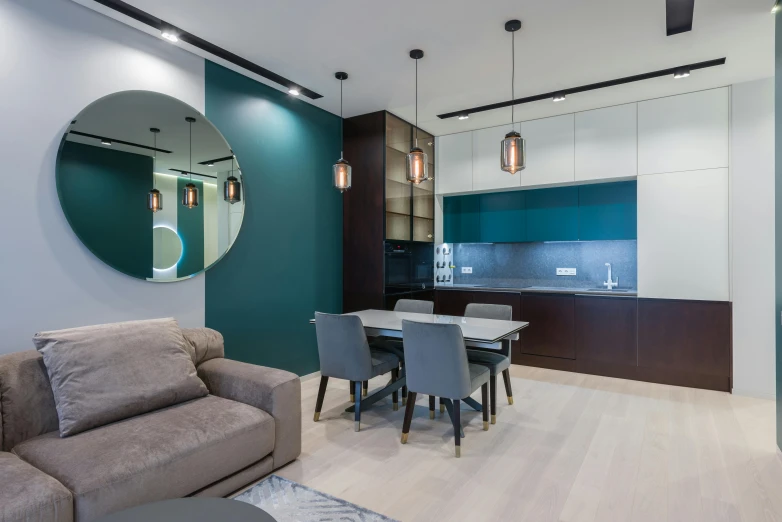 a living room filled with furniture and a round mirror, by Adam Marczyński, luxury bespoke kitchen design, teal color graded, kitchenette and conferenceroom, modern rustic”