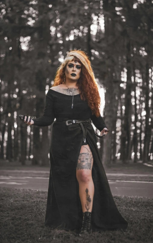 a woman in a black dress standing in a forest, an album cover, inspired by Kati Horna, pexels contest winner, gothic art, dressed in punk clothing, maiden with copper hair, leather robes, gothic tattoos