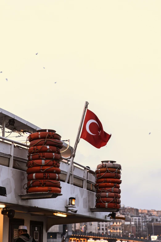 a group of people standing on top of a boat, an album cover, inspired by Niyazi Selimoglu, flickr, hurufiyya, flag, turkey, square, full frame image