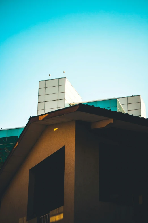 a couple of buildings that are next to each other, unsplash, modernism, simple gable roofs, 8k 50mm iso 10, college, front lit