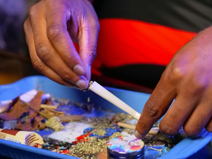 a close up of a person putting something in a container, process art, smoking a blunt, thumbnail, decoration, educational