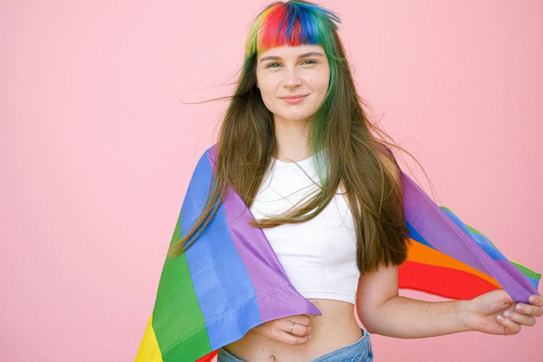 a beautiful young woman holding a rainbow colored kite, an album cover, trending on pexels, straight bangs, lgbt flag, greta thunberg smiling, wearing a pink head band