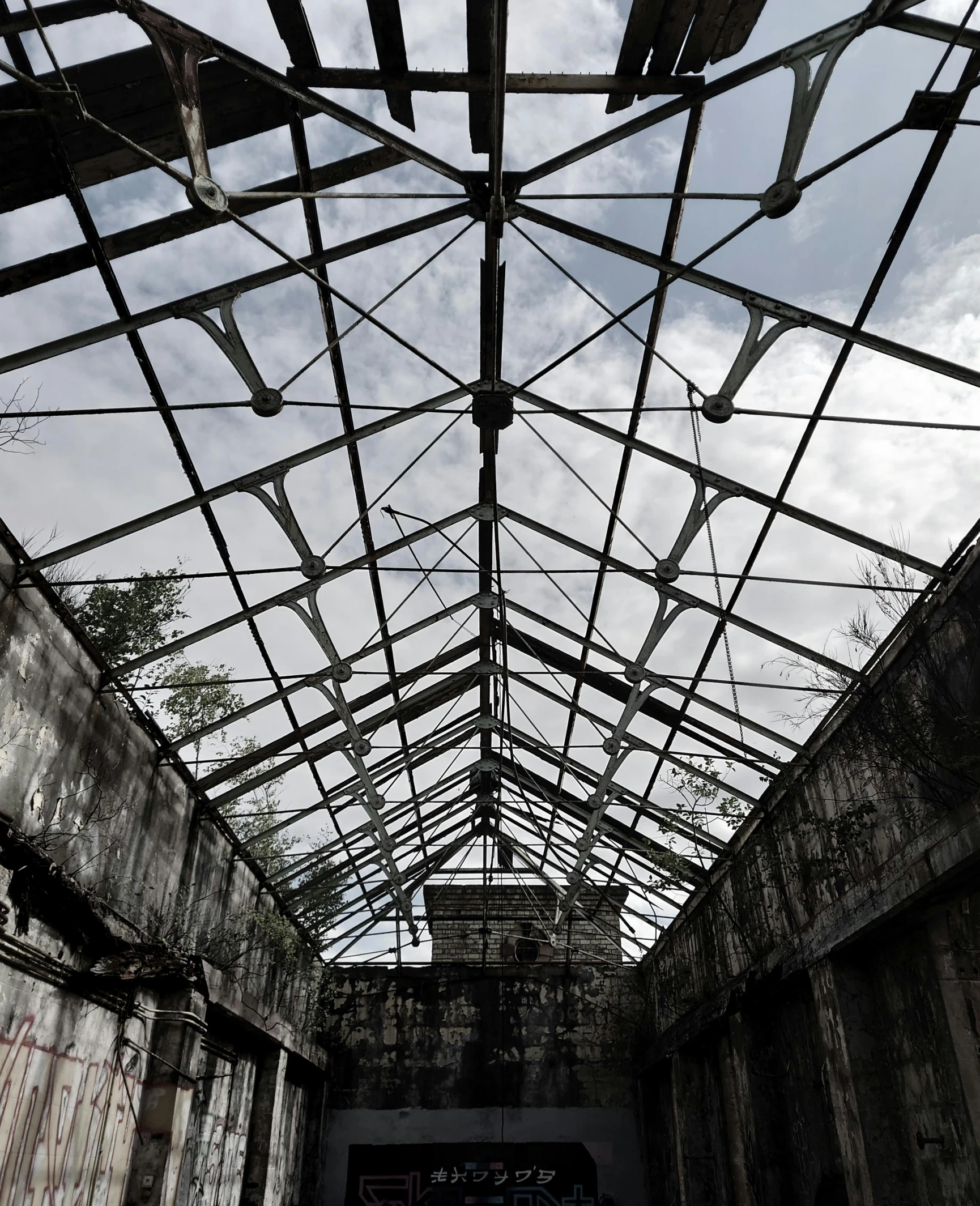 a view of the inside of an abandoned building, an album cover, inspired by Thomas Struth, unsplash contest winner, black steel buildings, looking upwards, promo image, prison