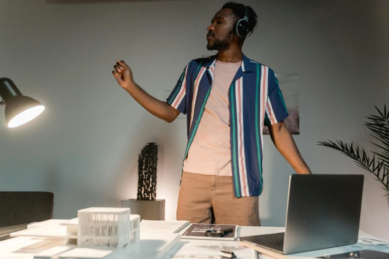 a man standing in front of a laptop computer, an album cover, pexels contest winner, happening, architectural model, mkbhd, wearing headset, in the gallery