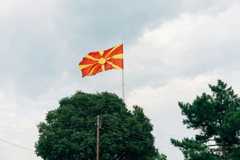 a red and yellow flag flying in the sky, jeszika le vye, square, pine, he is from virginia