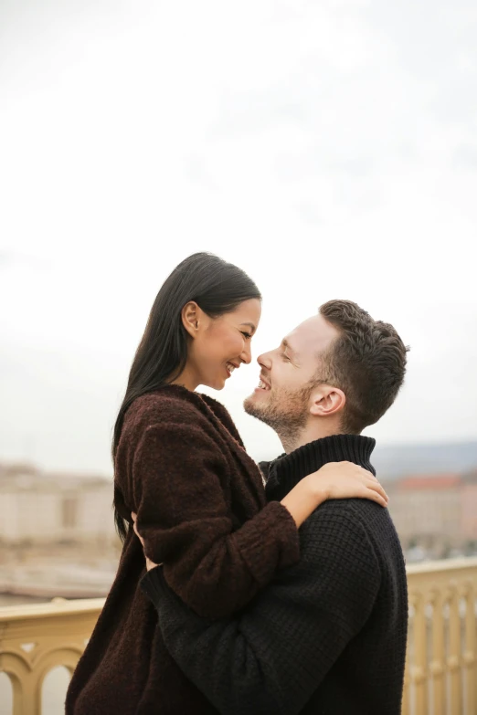 a man and woman standing next to each other on a balcony, pexels contest winner, happening, loving embrace, square, asian male, scandinavian