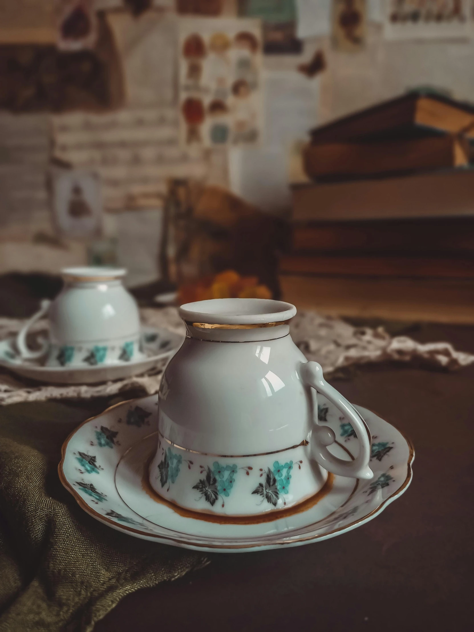 a cup and saucer sitting on top of a table, a still life, inspired by Elsa Bleda, trending on unsplash, arts and crafts movement, vintage closeup photograph, low quality photo, romanian, y2k”