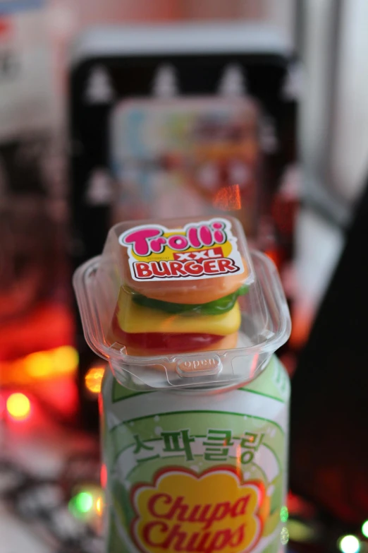 a close up of a container of food on a table, plastic toy, deathburger, jelly, product