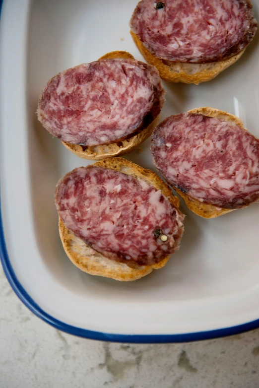 a close up of a plate of food on a table, salami, squish, grey, square