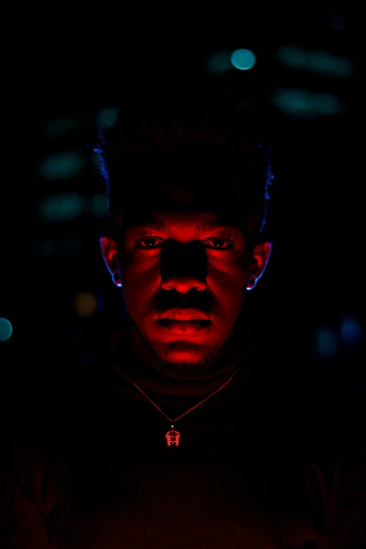 a man that is standing in the dark, an album cover, pexels, a teen black cyborg, reddish lighting, ((portrait)), lil uzi vert