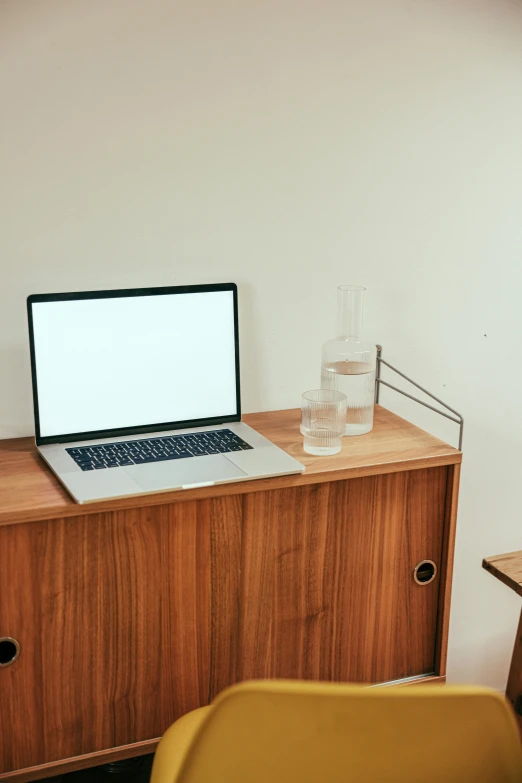 a laptop computer sitting on top of a wooden desk, unsplash, cabinet furniture, kyoto studio, ilustration, no text