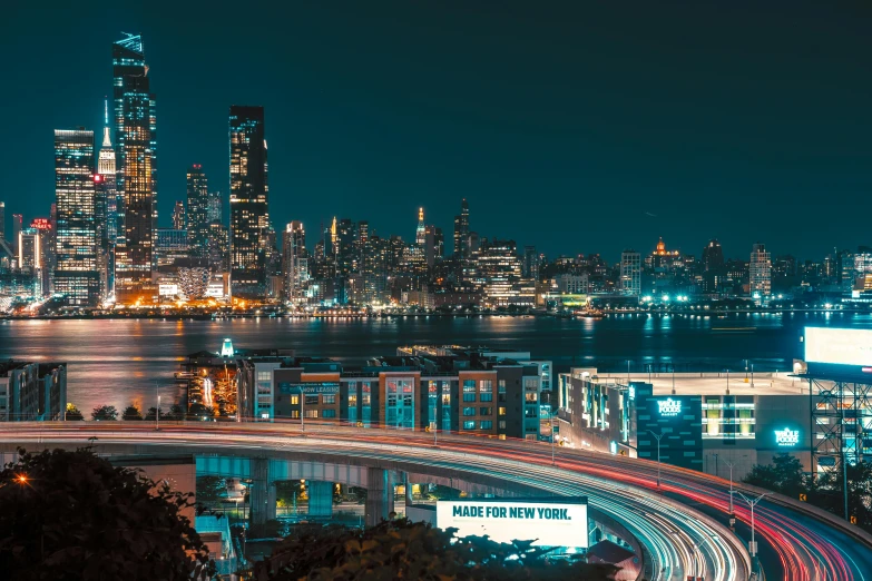 a view of a city at night from the top of a hill, a picture, inspired by Elsa Bleda, unsplash contest winner, new jersey, ultrawide lens”, teal lights, instagram photo