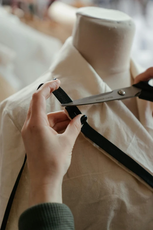 a person cutting a piece of fabric with a pair of scissors, inspired by René Burri, trending on pexels, renaissance, wearing collar on neck, lab coat, suspenders, closeup - view