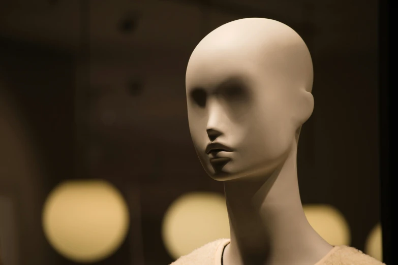 a close up of a mannequin wearing a sweater, a marble sculpture, trending on pexels, cone heads, cardboard, oval face, lit up