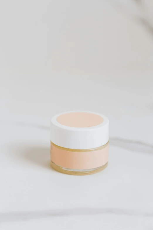 a jar of lip butter on a marble surface, by Will Ellis, gradient white to gold, light orange mist, soft zen minimalist, pastel matte colors