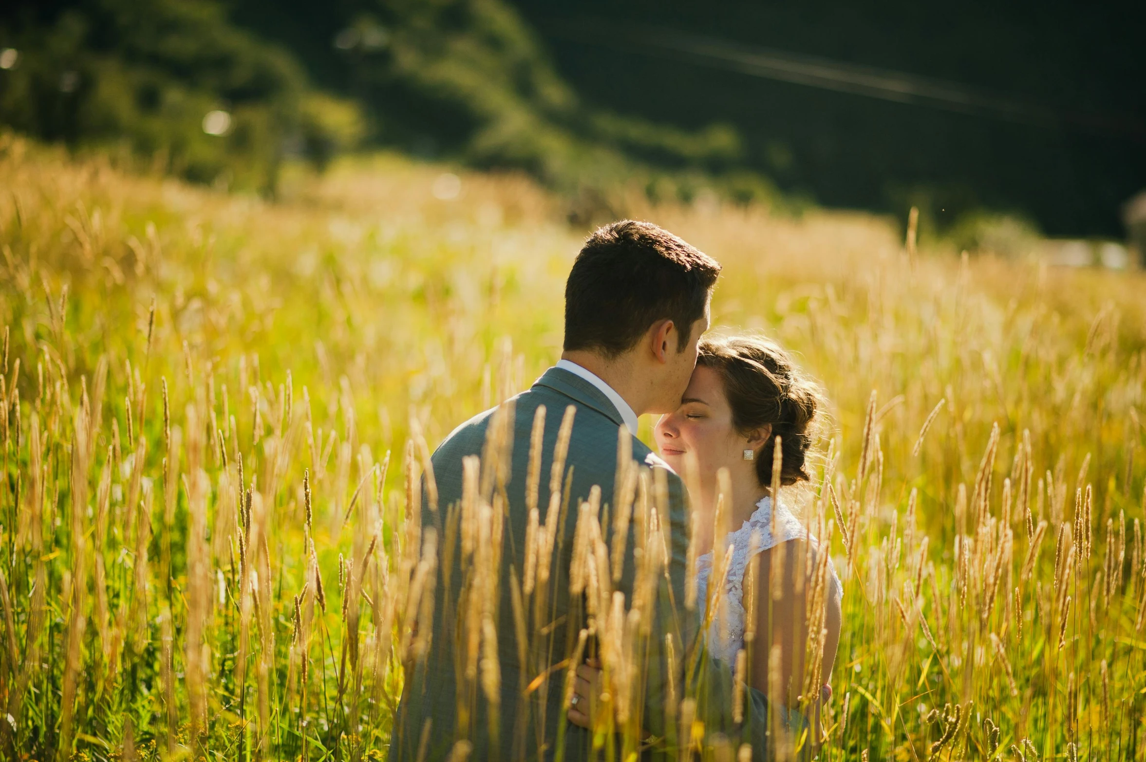 a bride and groom in a field of tall grass, by Julia Pishtar, unsplash, medium format. soft light, avatar image, tourist photo, lovely valley