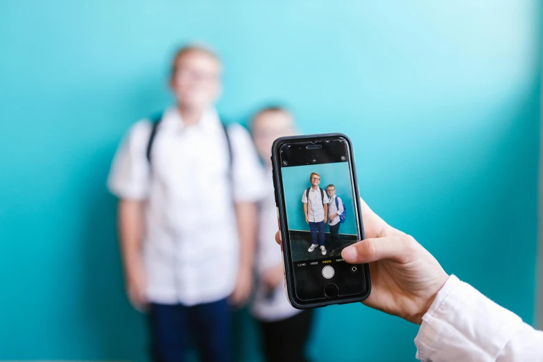 a person taking a picture with a cell phone, pupils visible, avatar image, lachlan bailey, official product photo